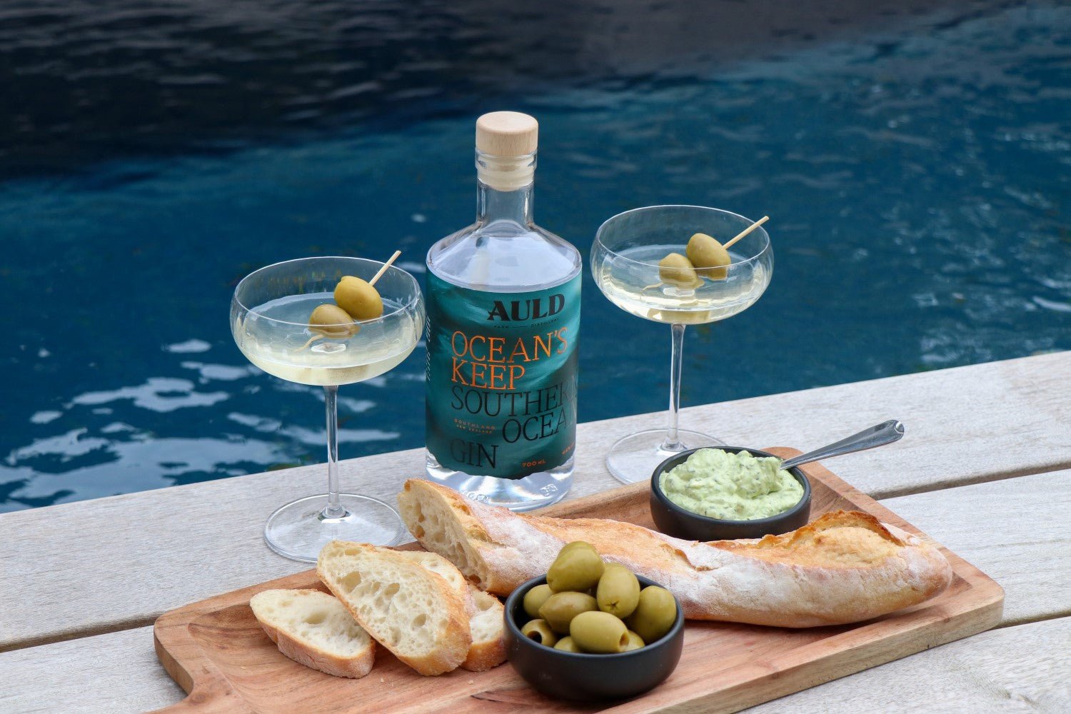 Gin and snack platter by pool